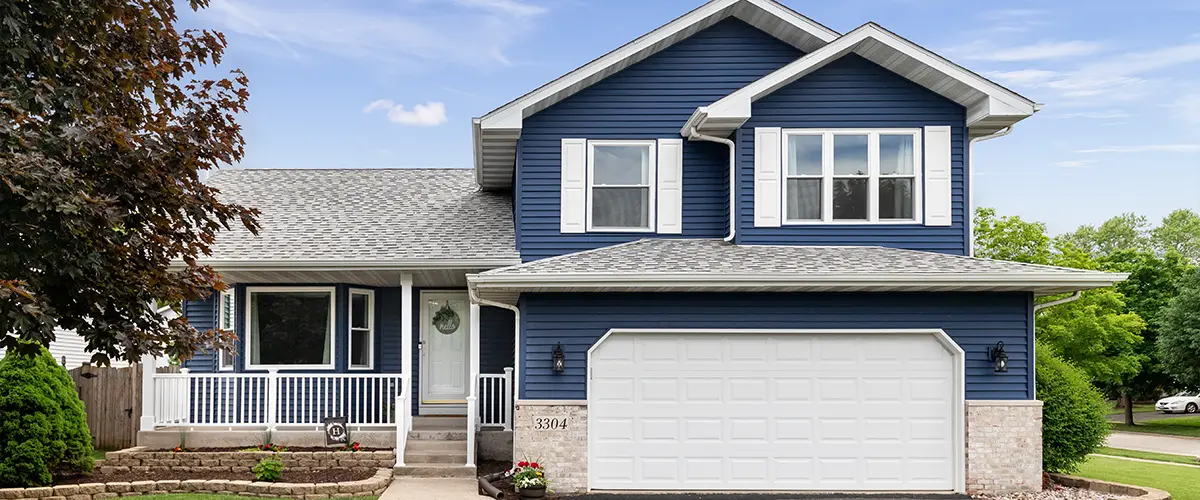Blue siding with a white garage door