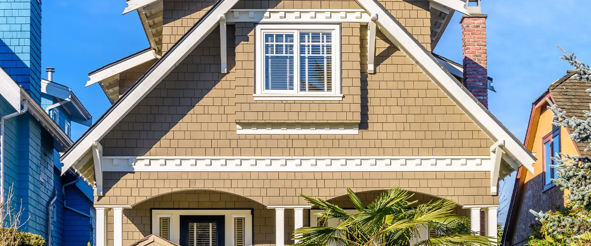 Brick home siding in a city with office buildings