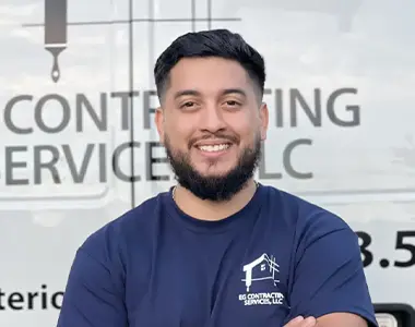 Erick Gonzalez, owner of EG Contracting Services, smiling in front of company vehicle in Centreville, VA