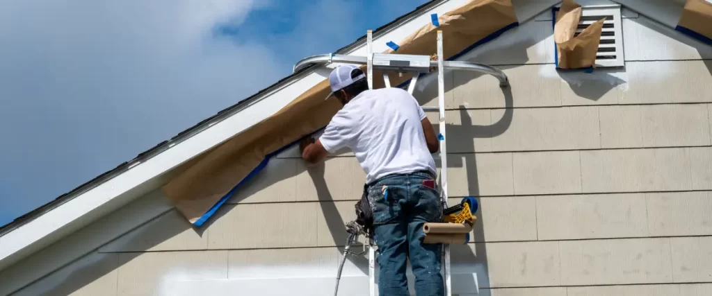 Close-up of painter prepping the roofline for painting