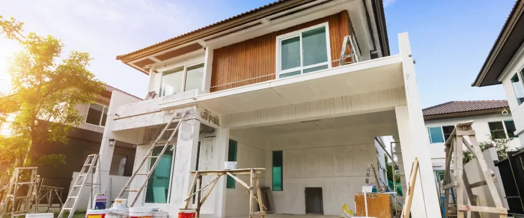Front view of a modern home in the process of exterior paint preparation